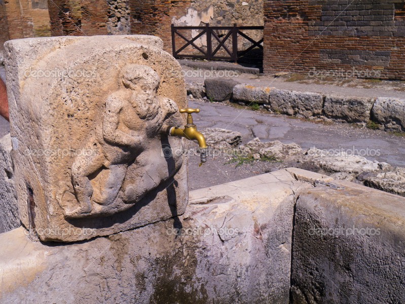 depositphotos-49710573-street-fountain-still-usable-in-the-ruins-in-the-once-buried-city-of-pompeii-italy